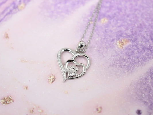 Collana d'argento con impronta di zampa e cuore in zirconi